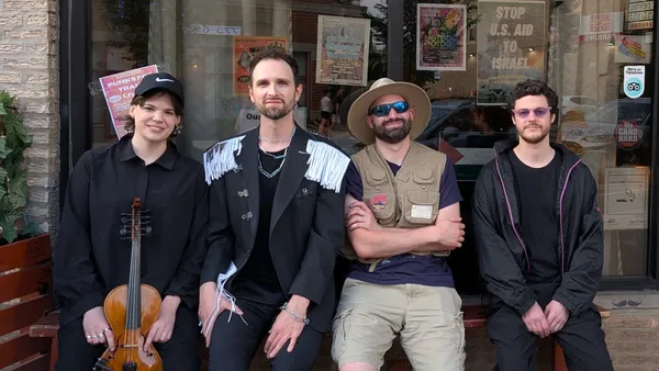 The four members of Pasha & The Pears outside Cafe Mustache in Chicago, one holding a violin