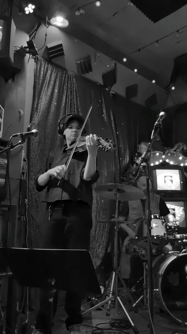 Black and white shot of the band performing on stage
